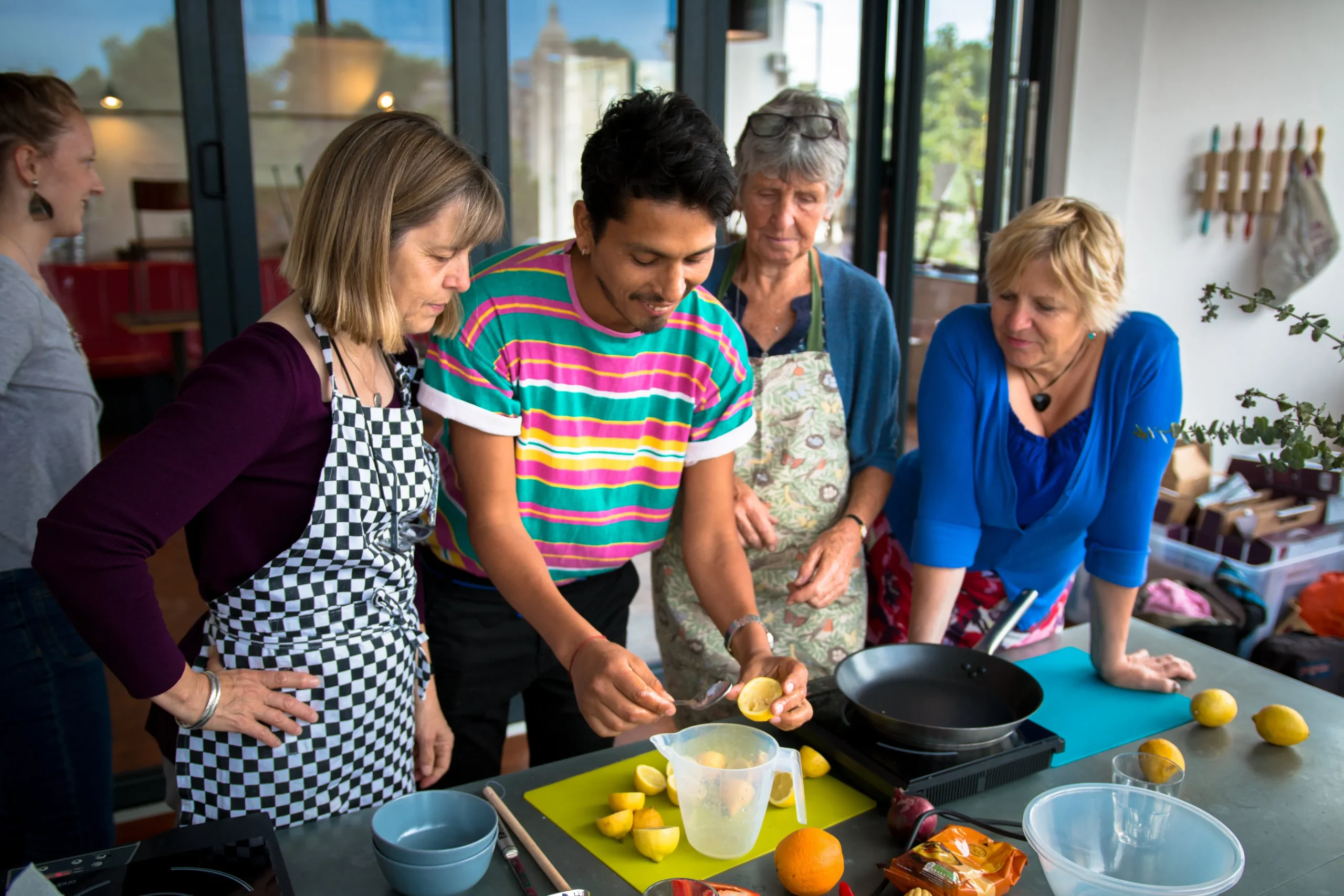 A migrateful chef preparing food with a group