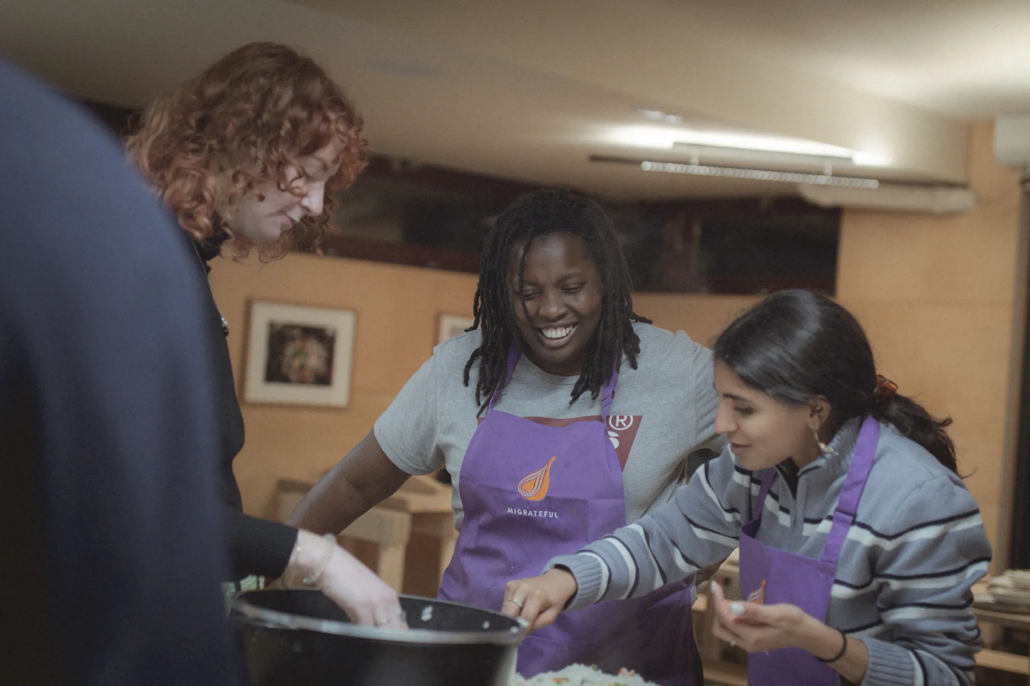Migrateful London Cookery Class- A group of people preparing food in a kitchen.